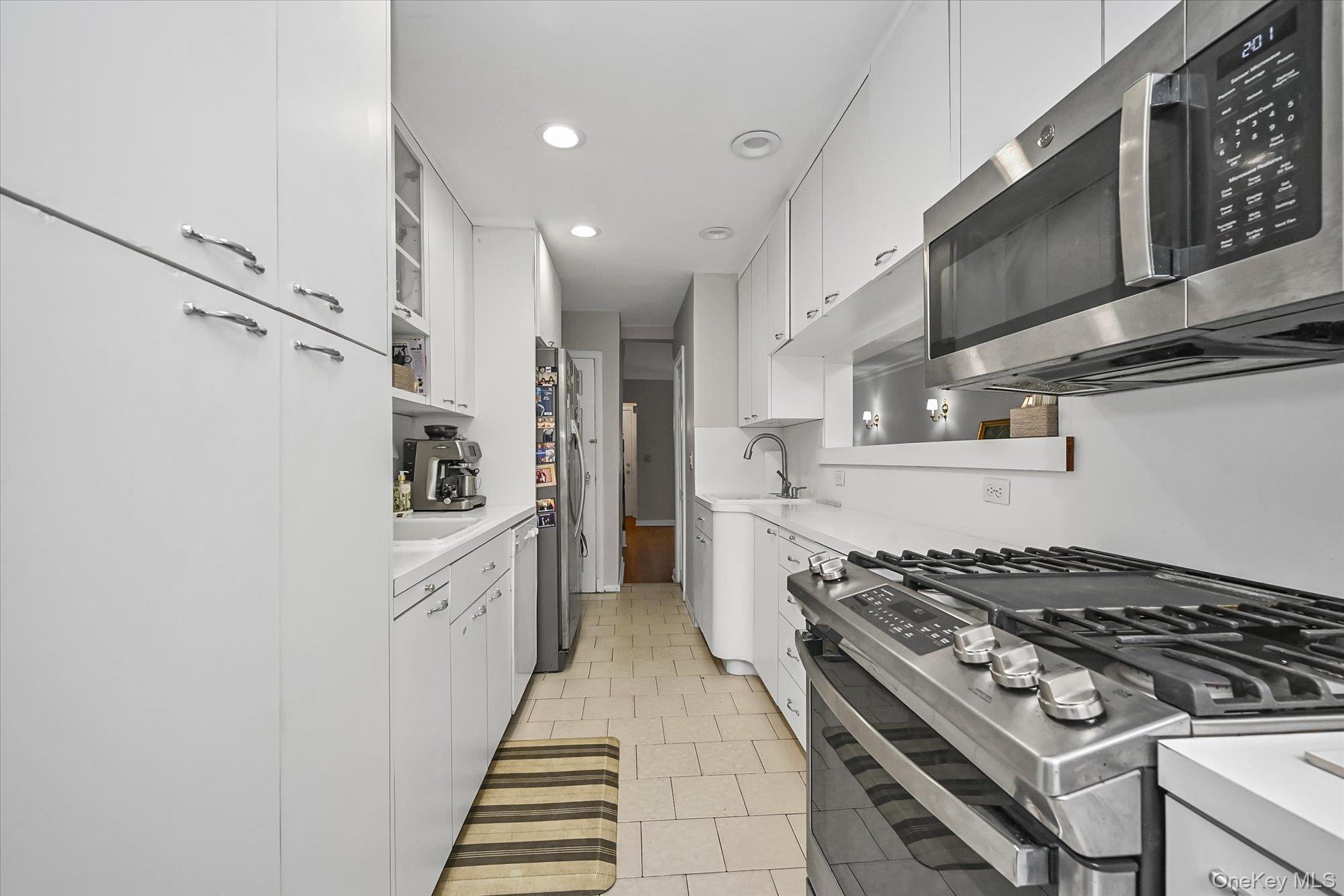 136-54 71st Road Queens, NY 11367 - Photo 14 of 25 a kitchen with stainless steel appliances granite countertop a stove and a refrigerator
