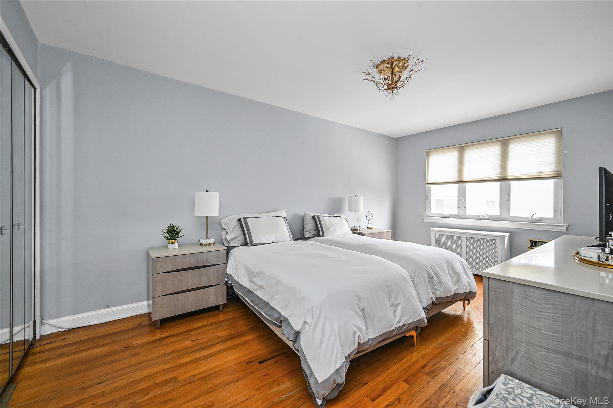 136-54 71st Road Queens, NY 11367 - Photo 16 of 25 a bedroom with a bed and window