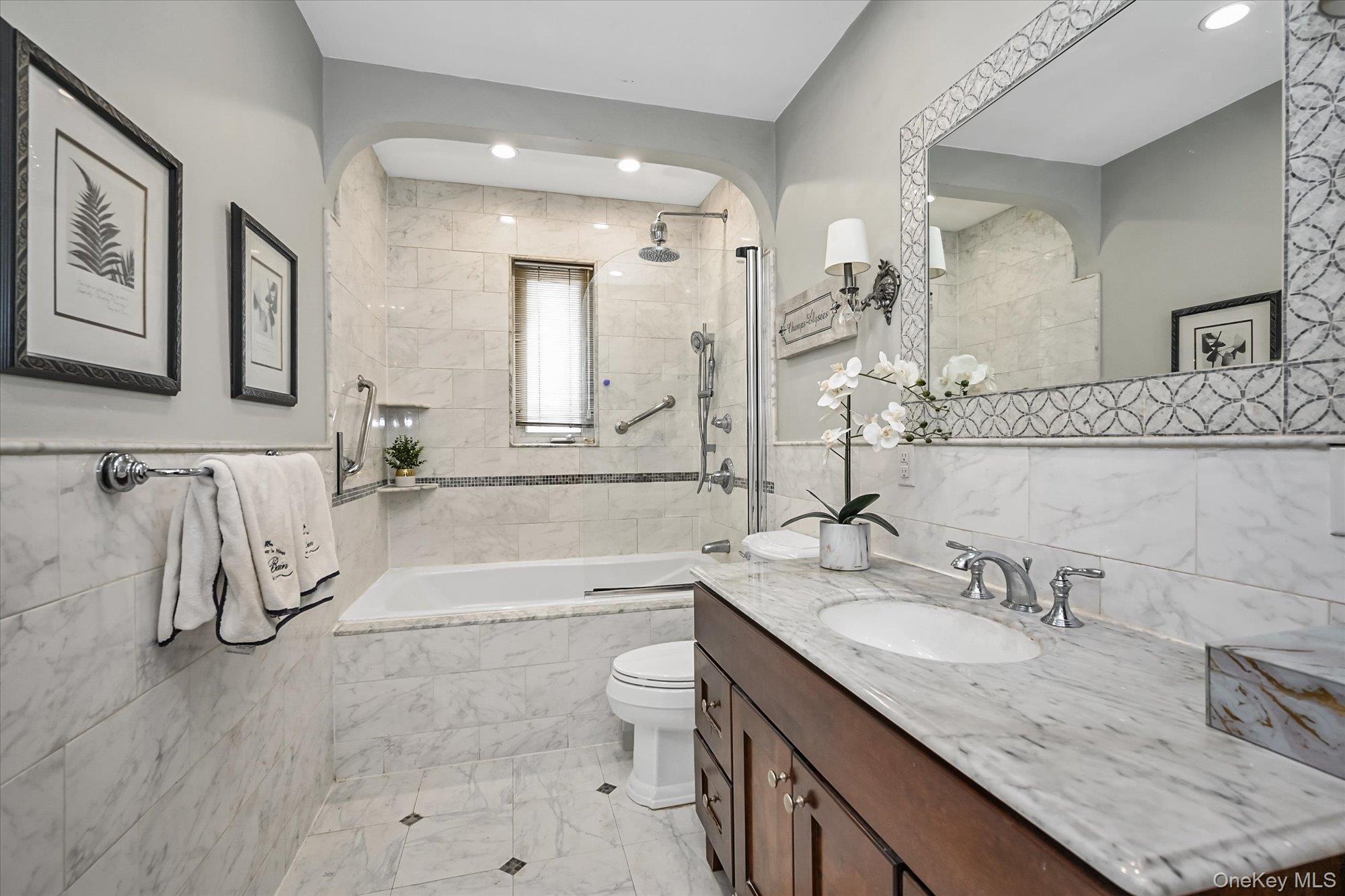 136-54 71st Road Queens, NY 11367 - Photo 17 of 25 a bathroom with a granite countertop sink a toilet and bathtub