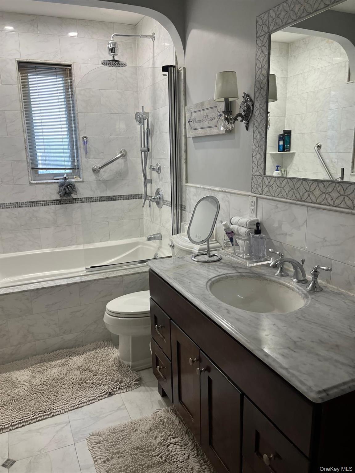 136-54 71st Road Queens, NY 11367 - Photo 18 of 25 a bathroom with a granite countertop sink a toilet and bathtub