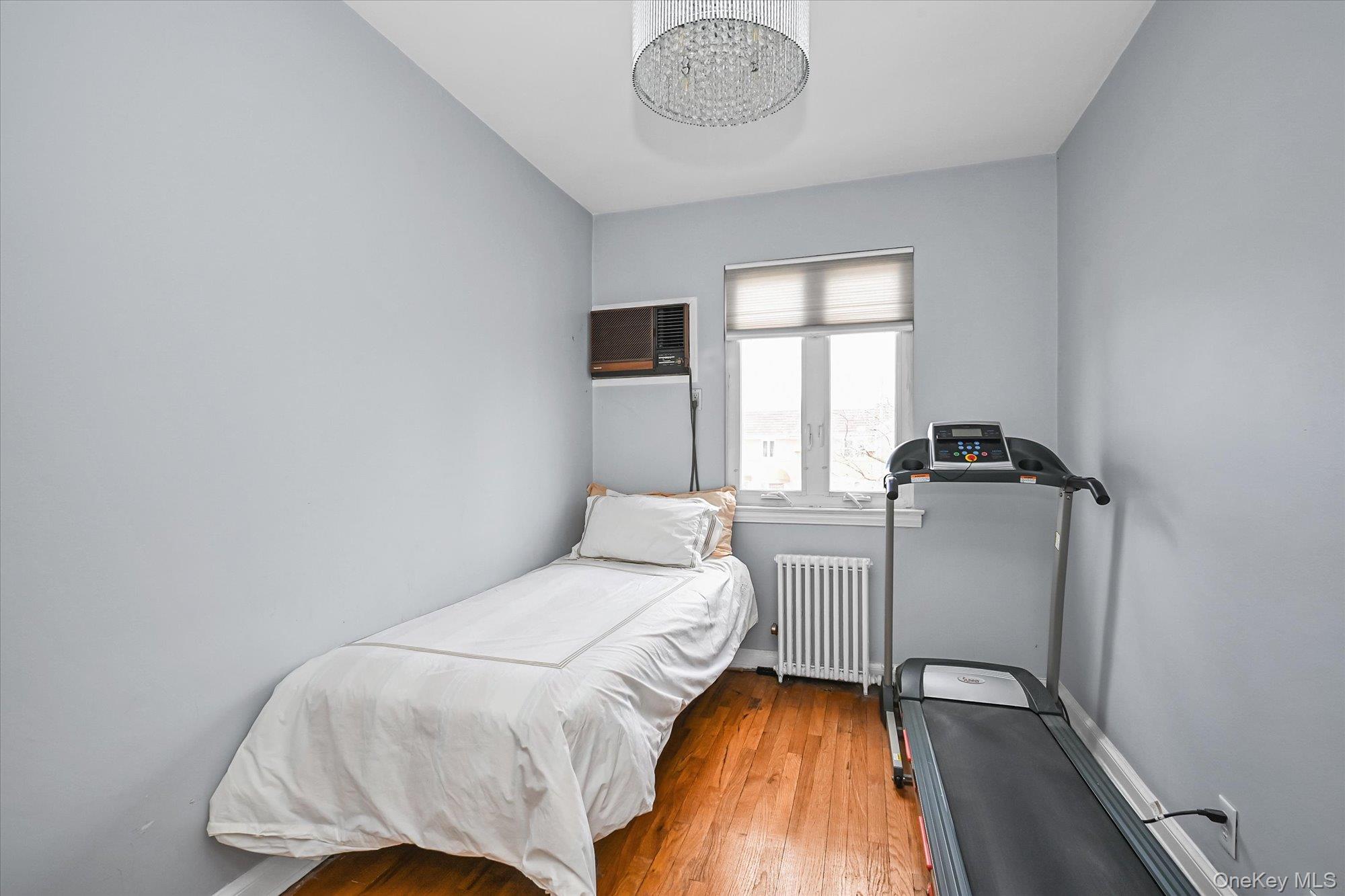 136-54 71st Road Queens, NY 11367 - Photo 19 of 25 a bedroom with a bed and a window