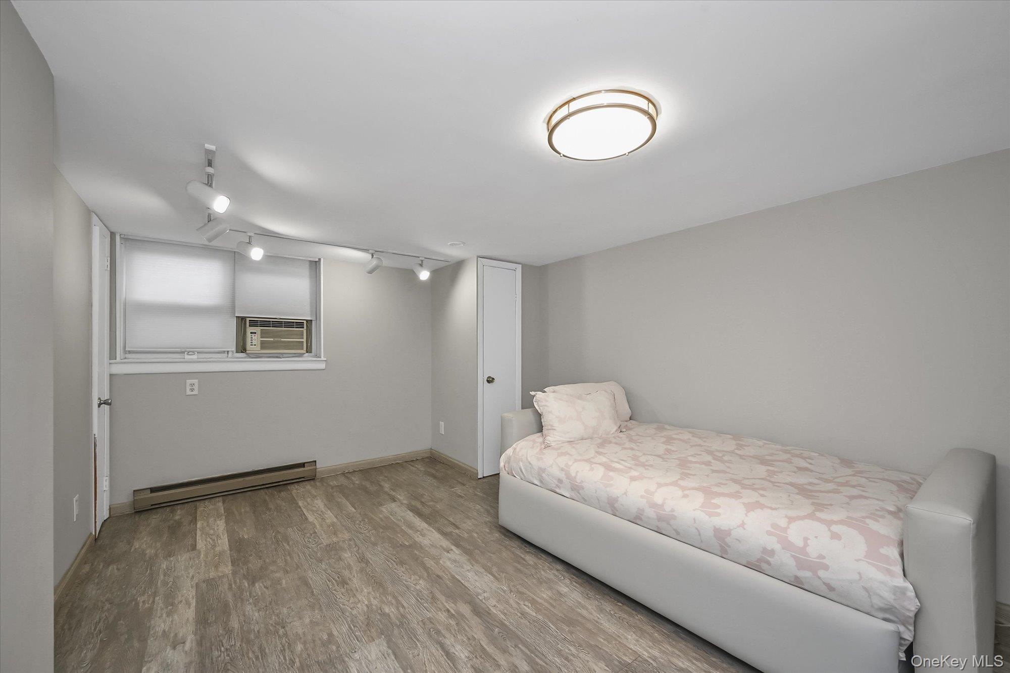 136-54 71st Road Queens, NY 11367 - Photo 21 of 25 a bedroom with a bed and a dresser