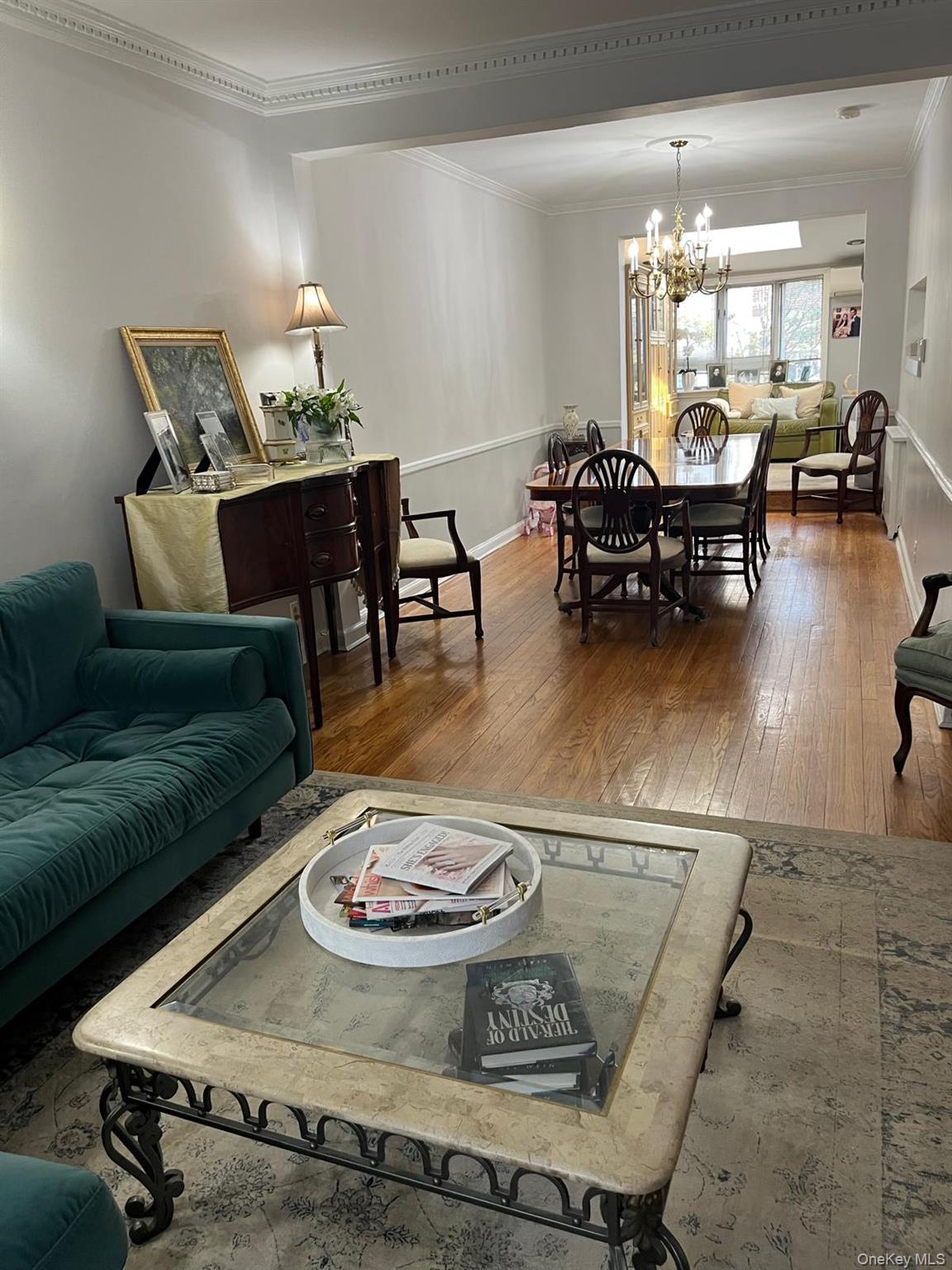 136-54 71st Road Queens, NY 11367 - Photo 7 of 25 a living room with furniture and a table