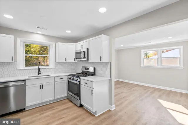 a kitchen with a stove a sink and a refrigerator