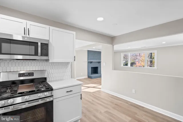a kitchen with stainless steel appliances granite countertop a stove and a microwave