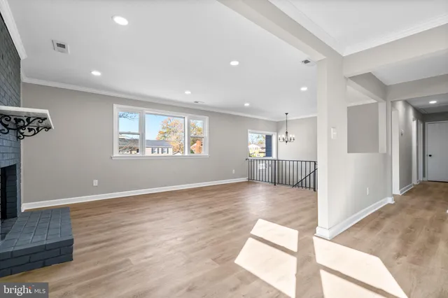 a view of empty room with wooden floor