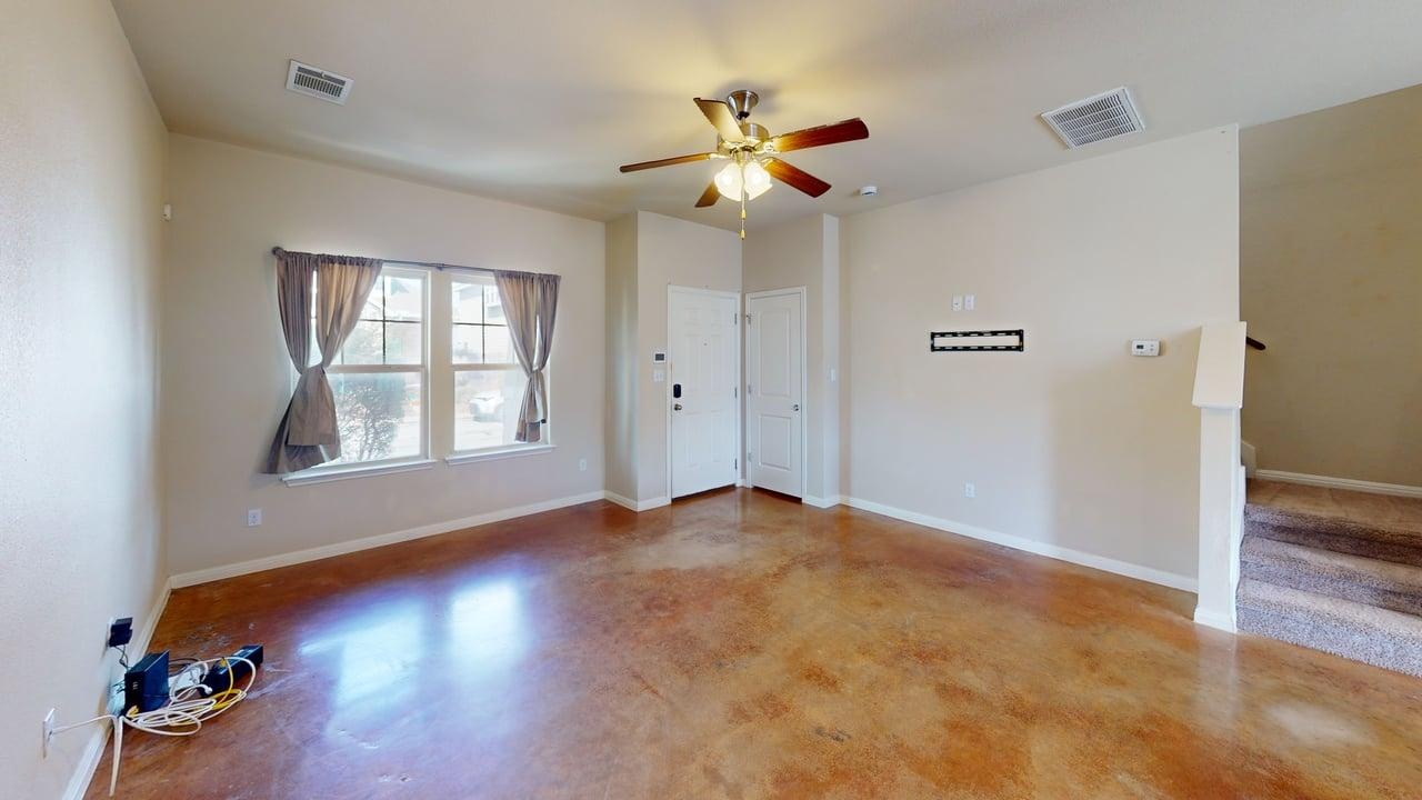 Spare room with finished concrete flooring and ceiling fan