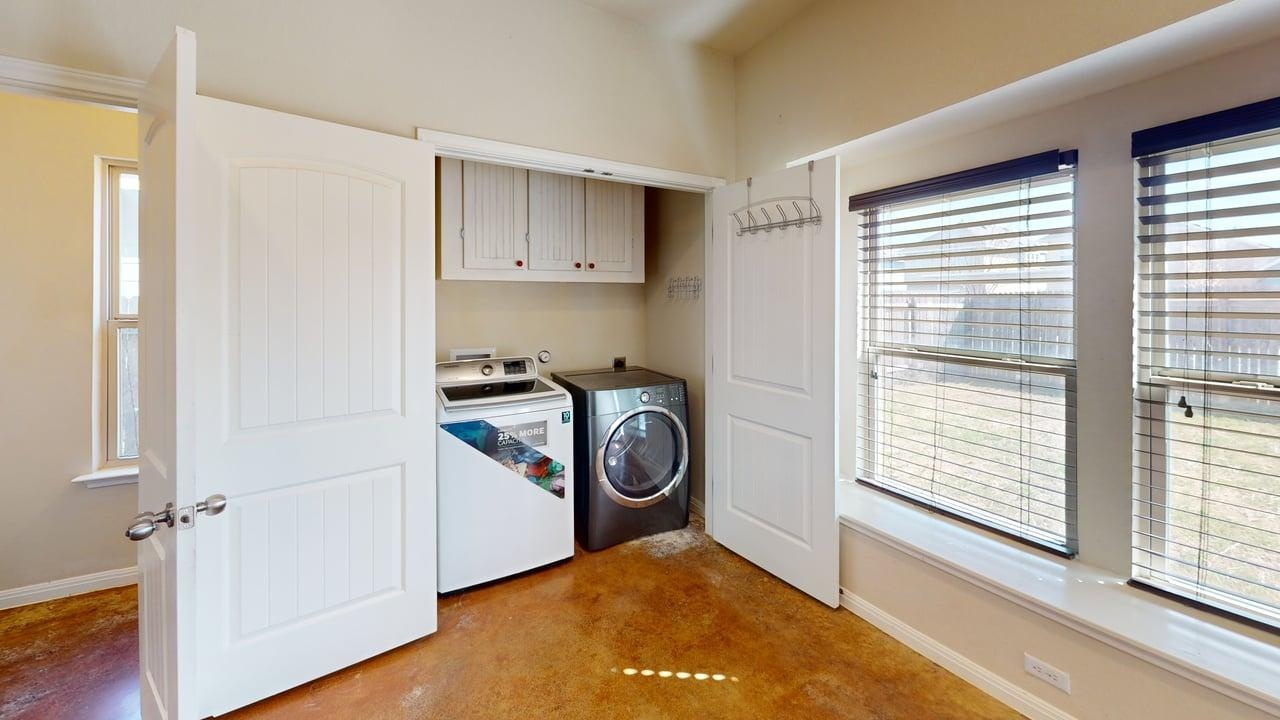 4621 Kind Way, Unit 271 Austin, TX 78742 - Photo 4 of 11 Laundry room featuring concrete flooring, washer and clothes dryer, and cabinet space