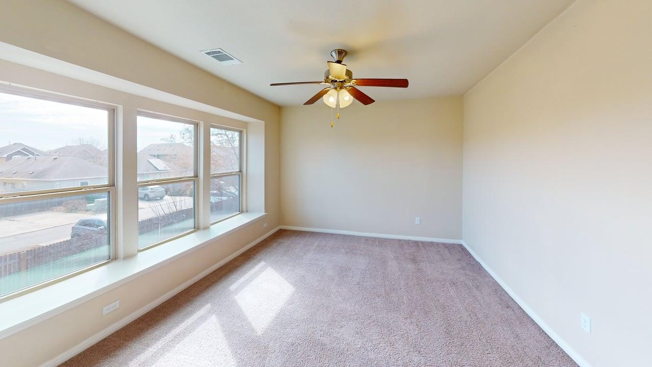 4621 Kind Way, Unit 271 Austin, TX 78742 - Photo 6 of 11 Empty room with light carpet and a ceiling fan