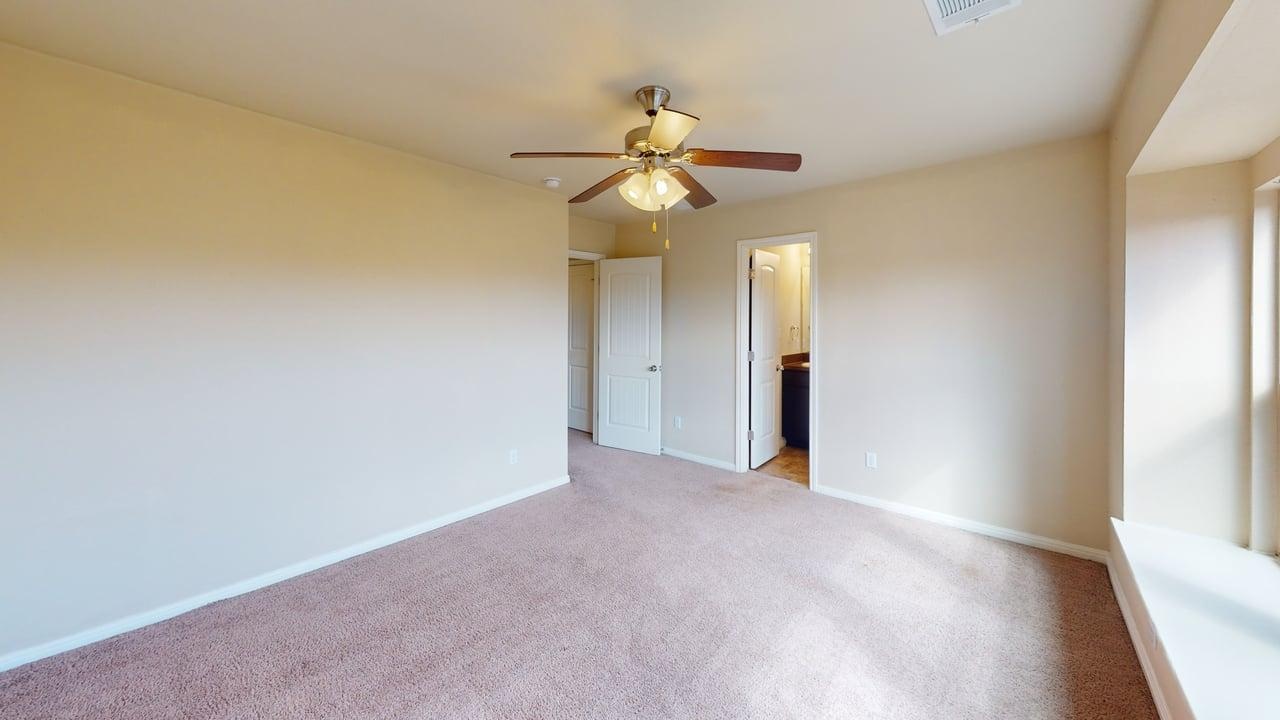 4621 Kind Way, Unit 271 Austin, TX 78742 - Photo 7 of 11 Unfurnished bedroom featuring carpet, ceiling fan, and ensuite bathroom