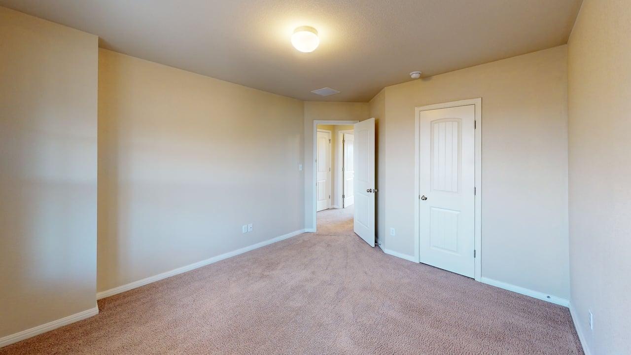 4621 Kind Way, Unit 271 Austin, TX 78742 - Photo 8 of 11 Unfurnished bedroom featuring baseboards and light colored carpet