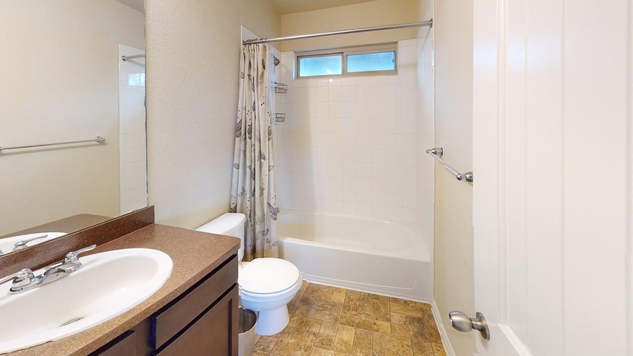 4621 Kind Way, Unit 271 Austin, TX 78742 - Photo 10 of 11 Full bath with vanity, shower / tub combo, and stone finish floors