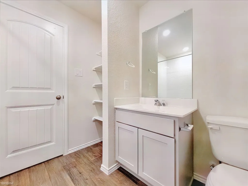 419 Sickle Loop Kyle, TX 78640 - Photo 20 of 35 A well-appointed bathroom with durable flooring and convenient storage shelves.