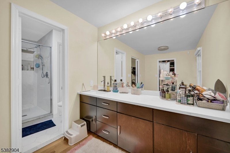 30 County Rte 635 Livingston, NJ 07039 - Photo 12 of 40 a bathroom with a sink double vanity and shower