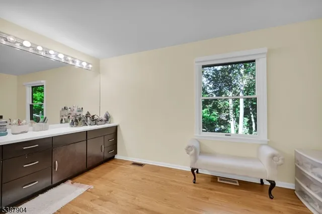 a spacious bathroom with a double vanity sink and a mirror