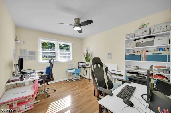 a view of a workspace with furniture and a window