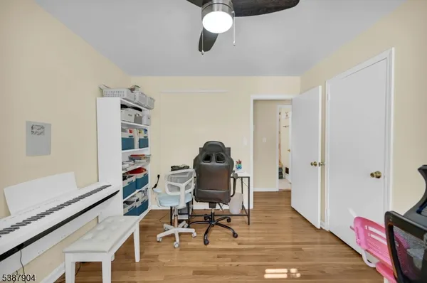 a workspace with furniture wooden floor and windows