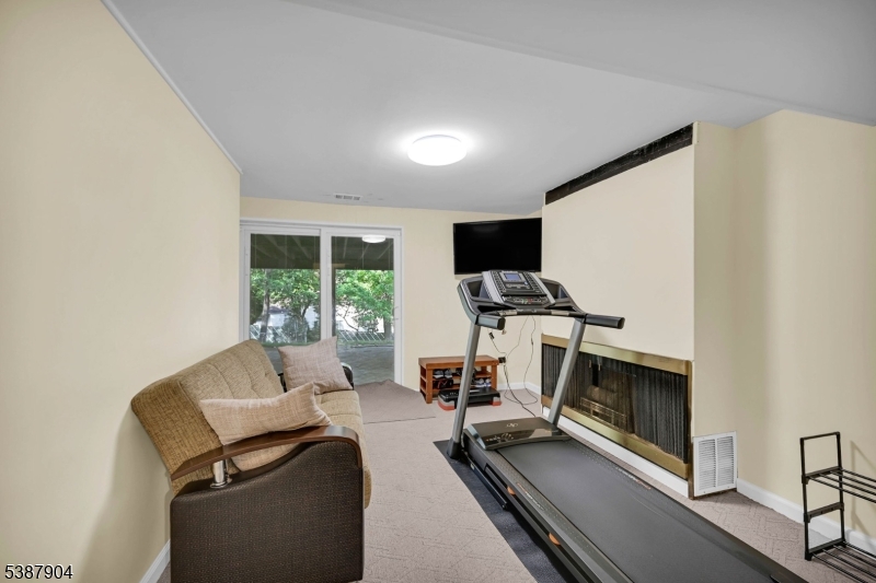 30 County Rte 635 Livingston, NJ 07039 - Photo 20 of 40 a work room with furniture and a flat screen tv