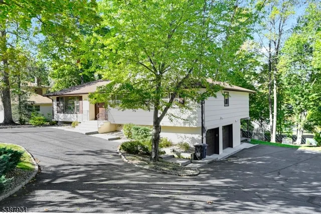 a view of a house with a yard and tree