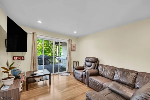 a living room with furniture ceiling fan and a flat screen tv