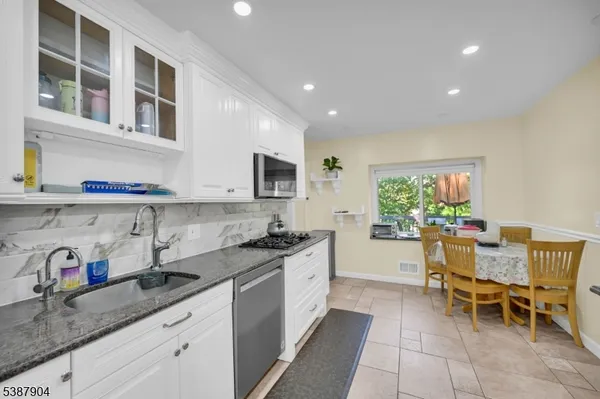 a kitchen with a sink and chairs