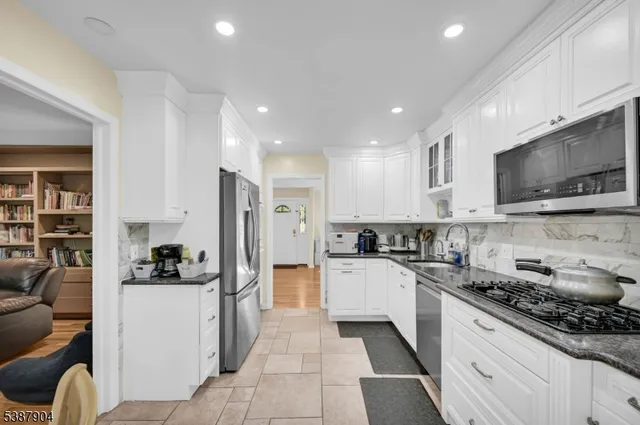a kitchen with stainless steel appliances granite countertop a refrigerator sink and cabinets