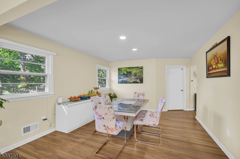 30 County Rte 635 Livingston, NJ 07039 - Photo 29 of 40 a dining room with wooden floor and a window