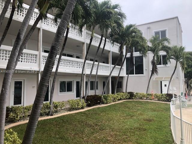7905 East Drive, Unit 9C North Bay Village, FL 33141 - Photo 2 of 11 front view of house with a yard
