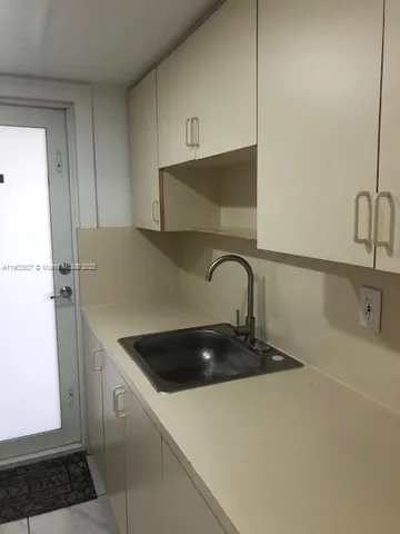 a kitchen with a sink and a refrigerator
