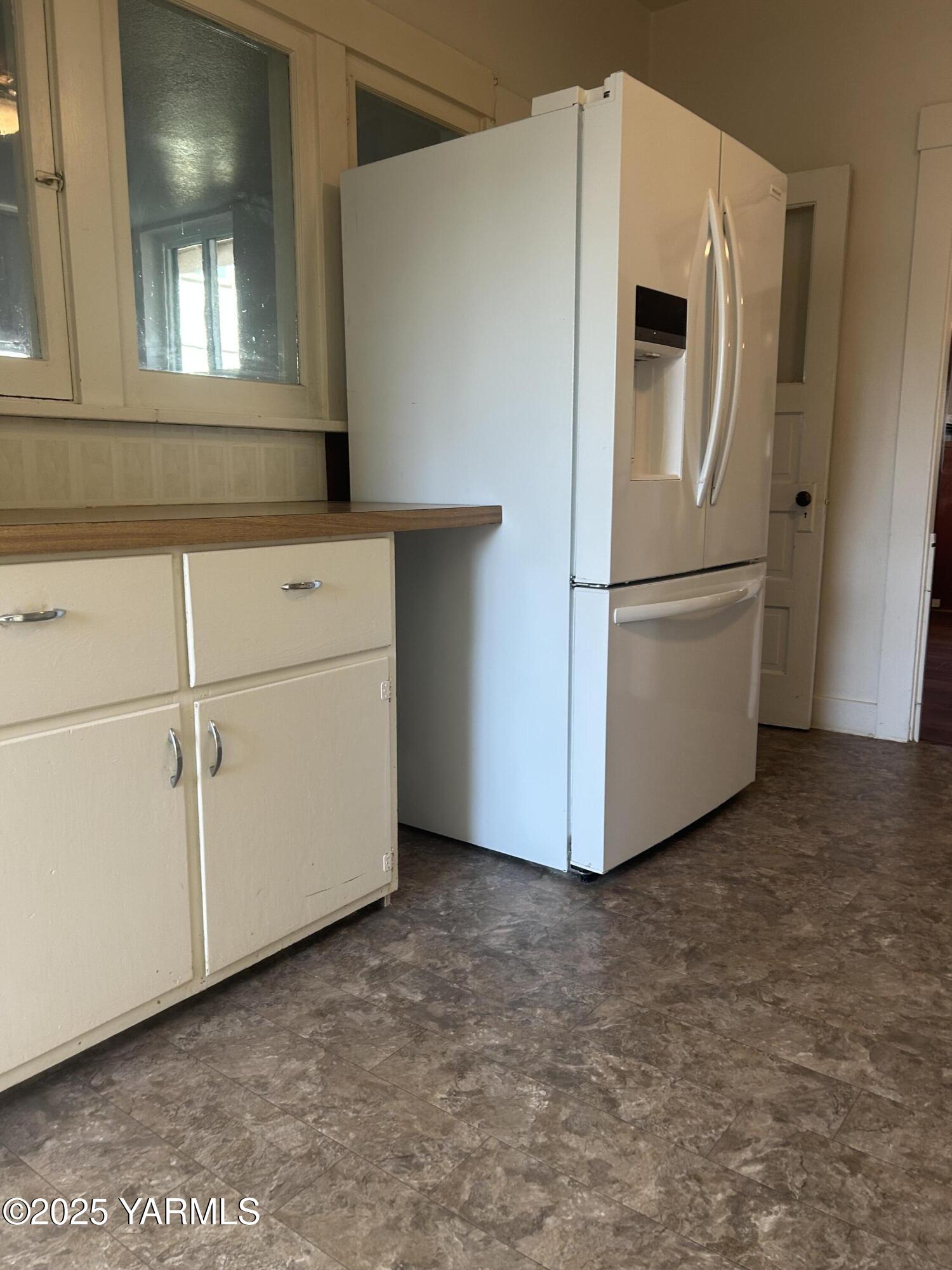 1110 South 8th Avenue Yakima, WA 98902 - Photo 24 of 25 a white refrigerator freezer sitting in a kitchen