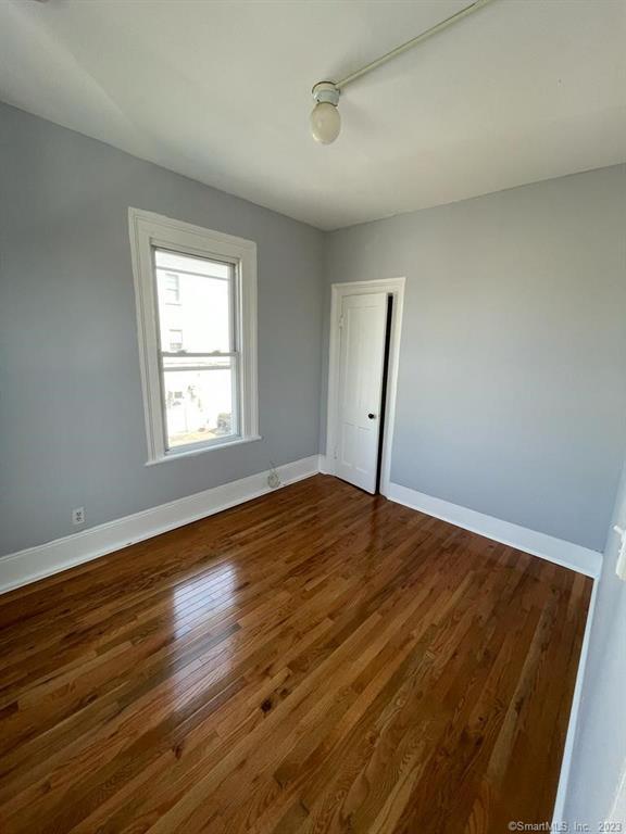358 Grand Street, Unit 2 Bridgeport, CT 06604 - Photo 1 of 1 a view of empty room with wooden floor and fan