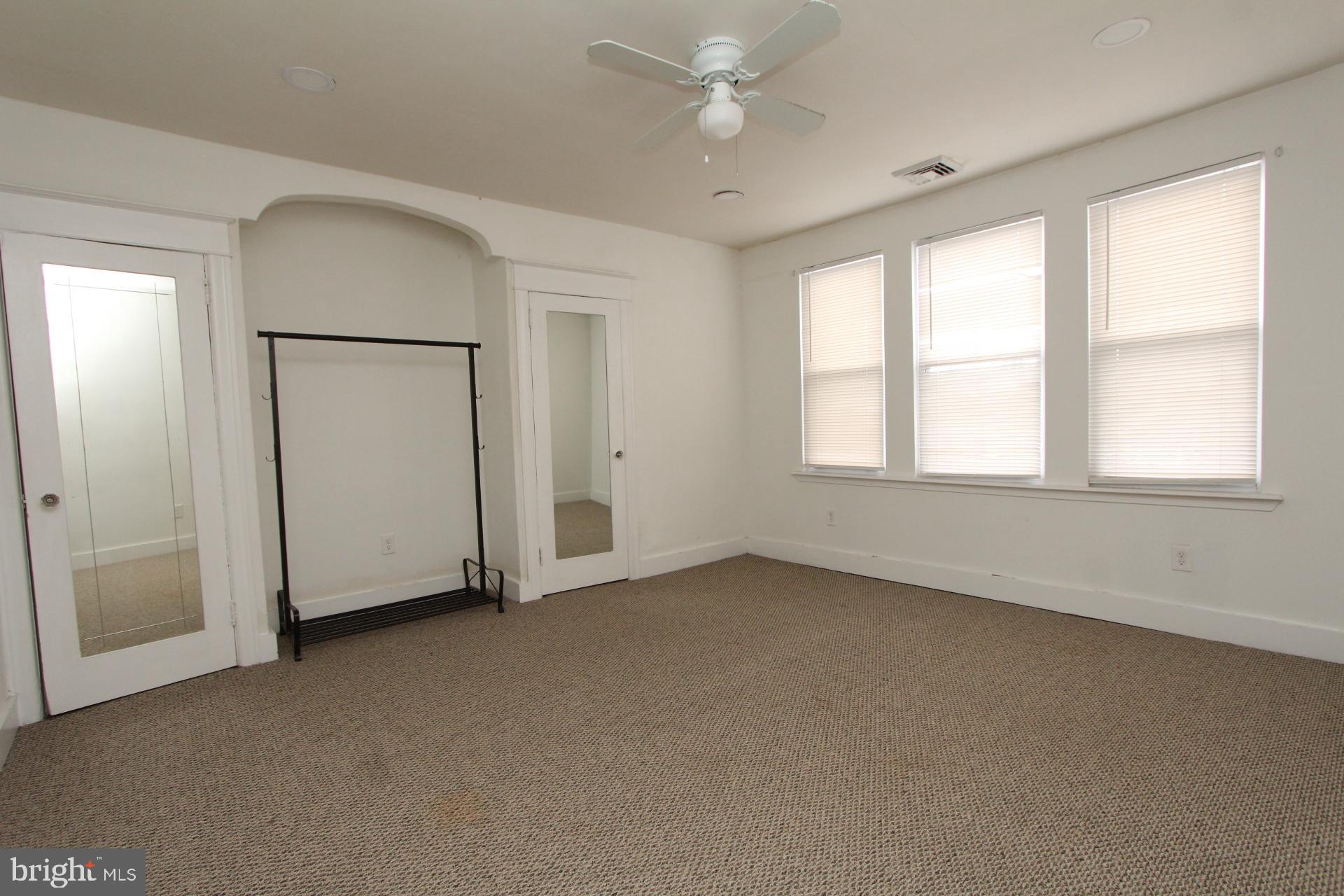 2311 Rhawn Street Philadelphia, PA 19152 - Photo 14 of 34 an empty room with chandelier fan and windows