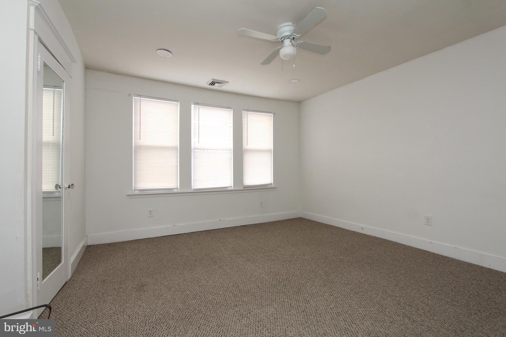 2311 Rhawn Street Philadelphia, PA 19152 - Photo 15 of 34 an empty room with a window and a ceiling fan