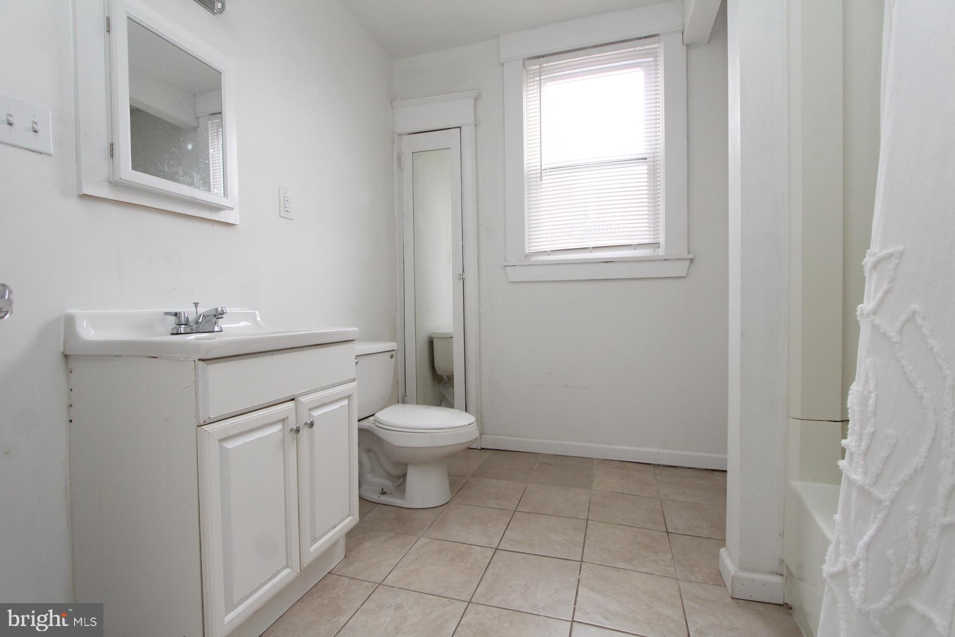 2311 Rhawn Street Philadelphia, PA 19152 - Photo 18 of 34 a bathroom with a sink toilet and window