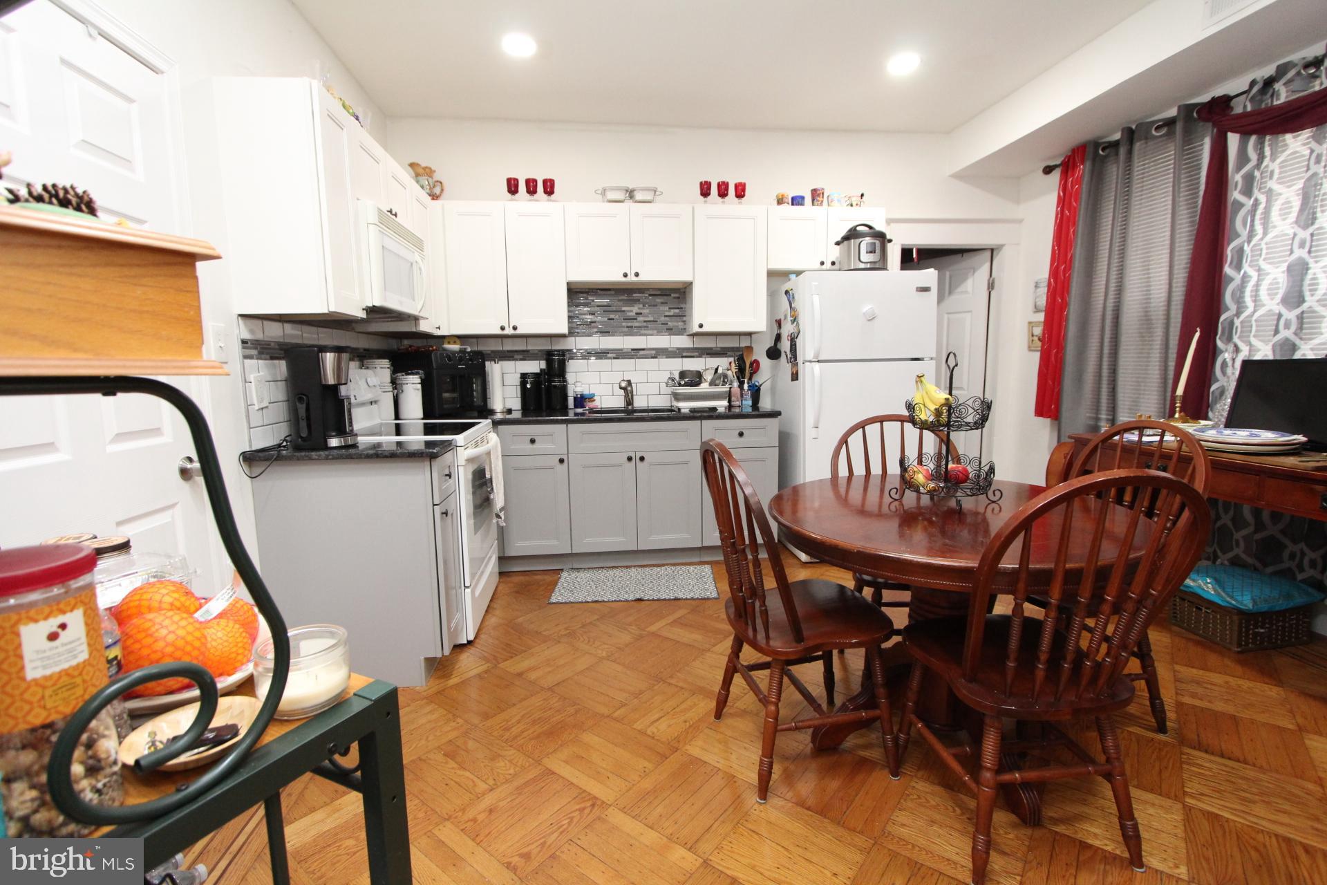 2311 Rhawn Street Philadelphia, PA 19152 - Photo 21 of 34 a kitchen with stainless steel appliances granite countertop a dining table and chairs