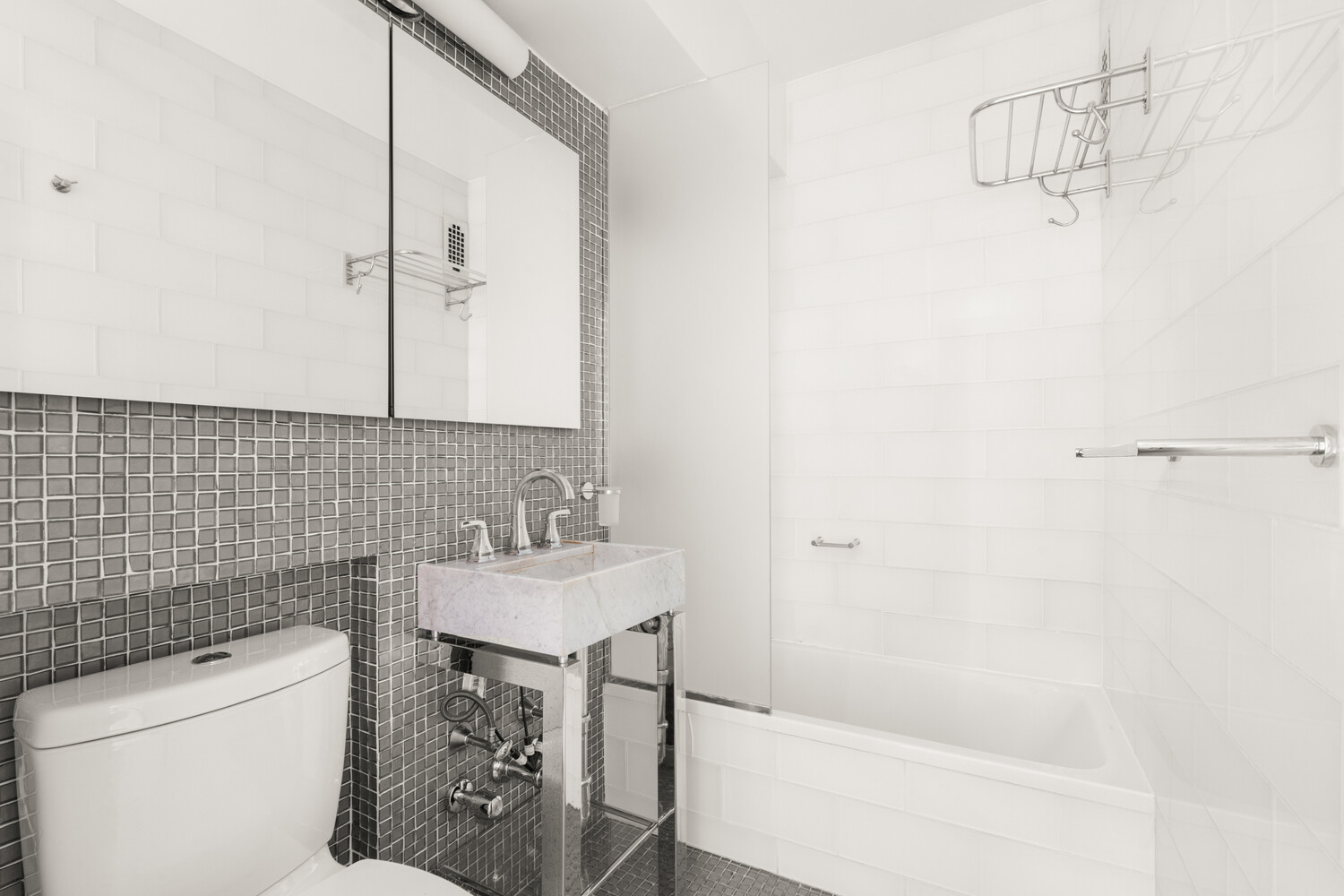 240 East 76th Street, Unit 8G Manhattan, NY 10021 - Photo 6 of 8 a bathroom with a sink toilet and shower