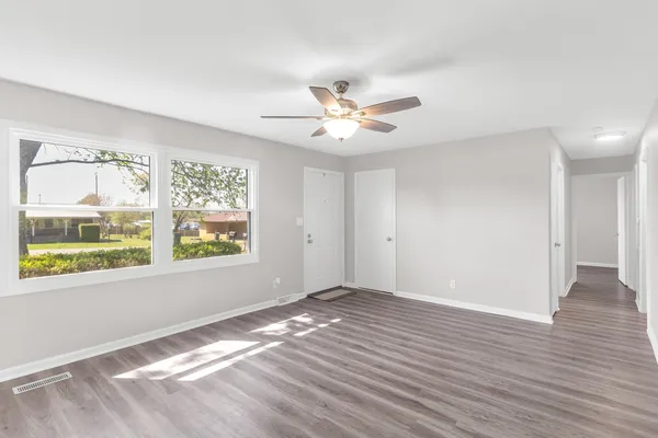wooden floor in an empty room with a window