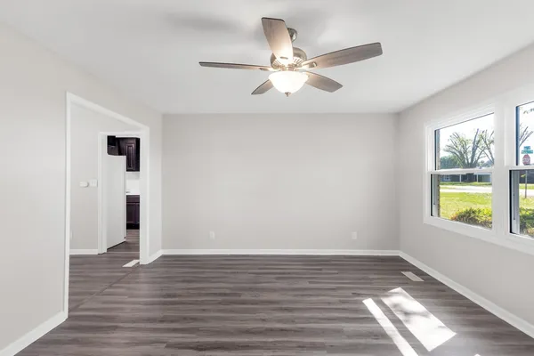 wooden floor in an empty room with a window