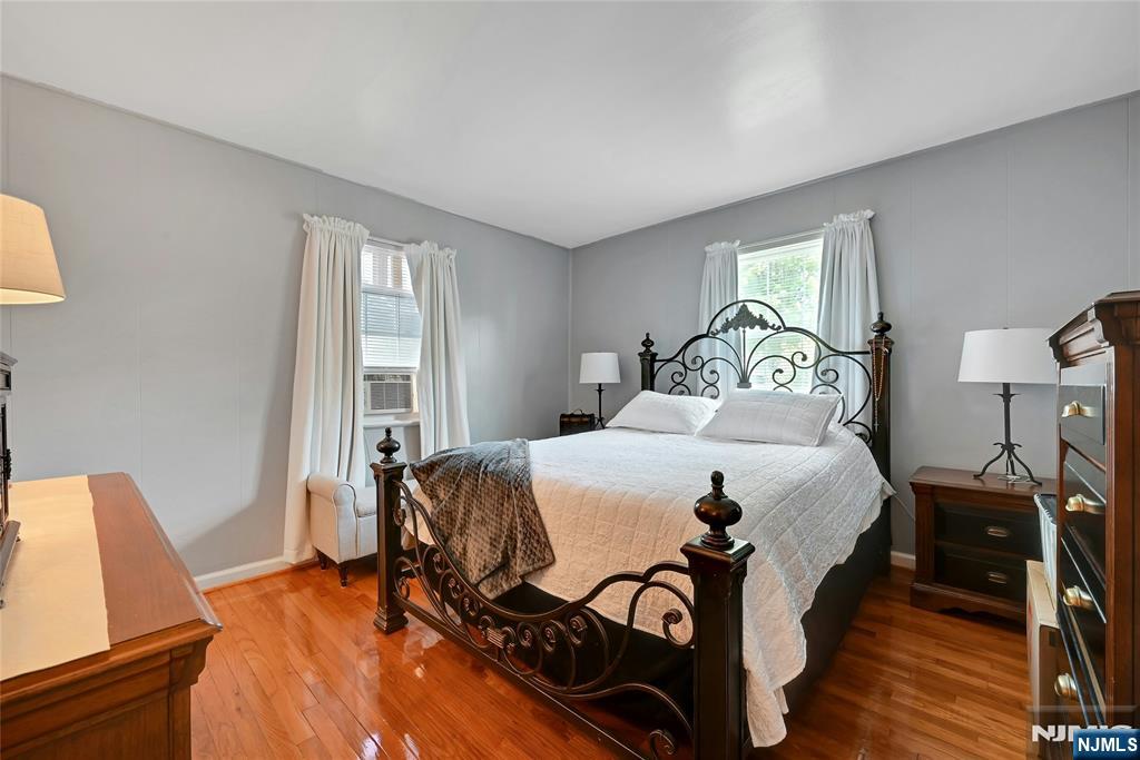 85 Edison Street Clifton, NJ 07013 - Photo 13 of 28 a bedroom with a bed and wooden floor
