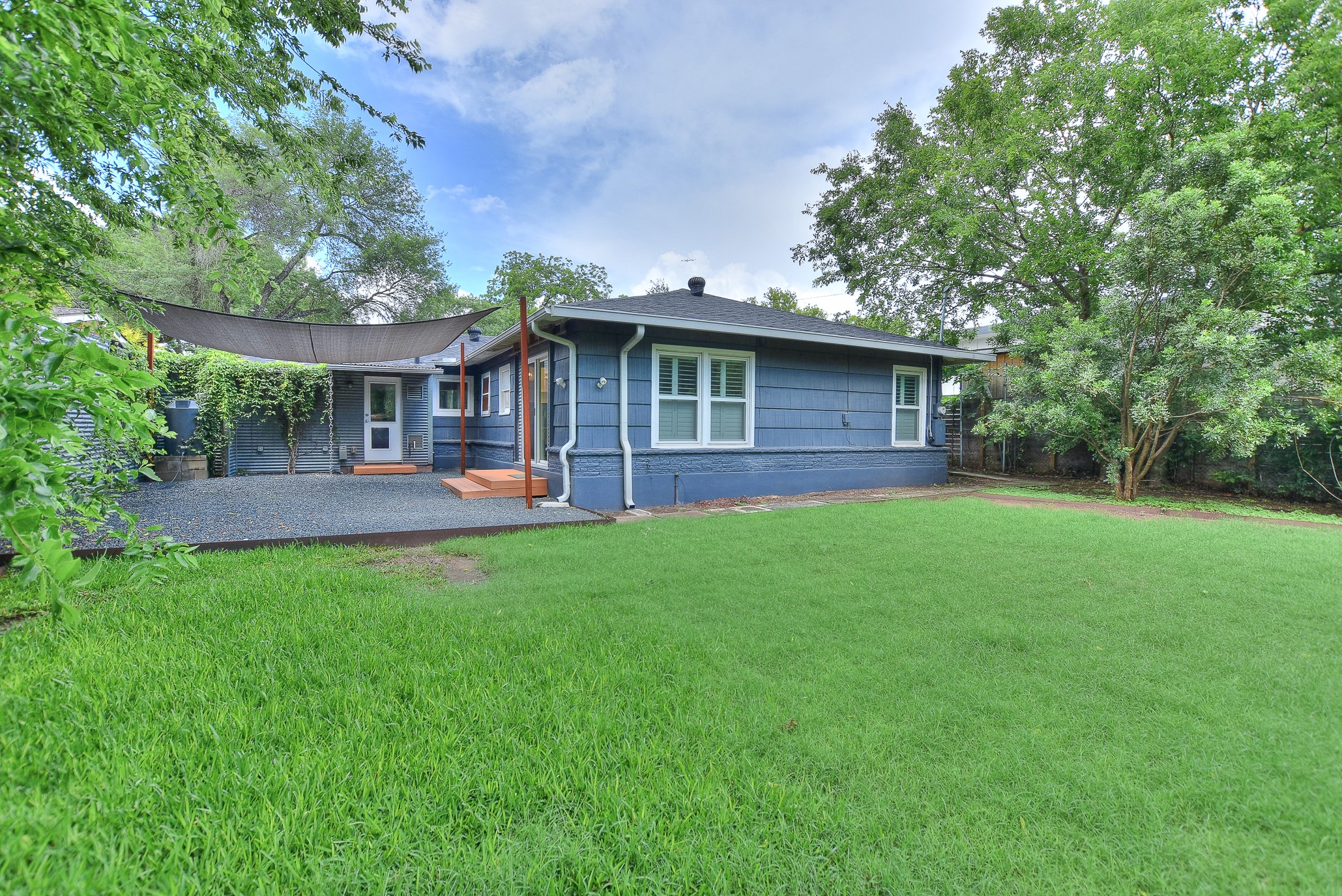 1309 Ridgemont Drive Austin, TX 78723 - Photo 31 of 35 This home offers established lush landscaping and trees but leaves plenty of room to create your own personal spaces!