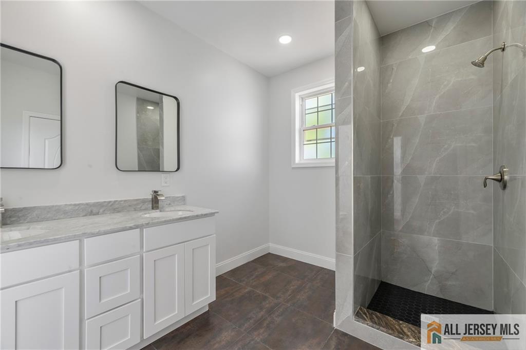 452 Raritan Boulevard Old Bridge, NJ 07735 - Photo 12 of 29 a bathroom with a sink a light fixture and a window