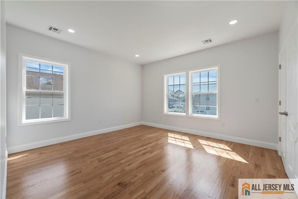 452 Raritan Boulevard Old Bridge, NJ 07735 - Photo 13 of 29 an empty room with wooden floor and windows