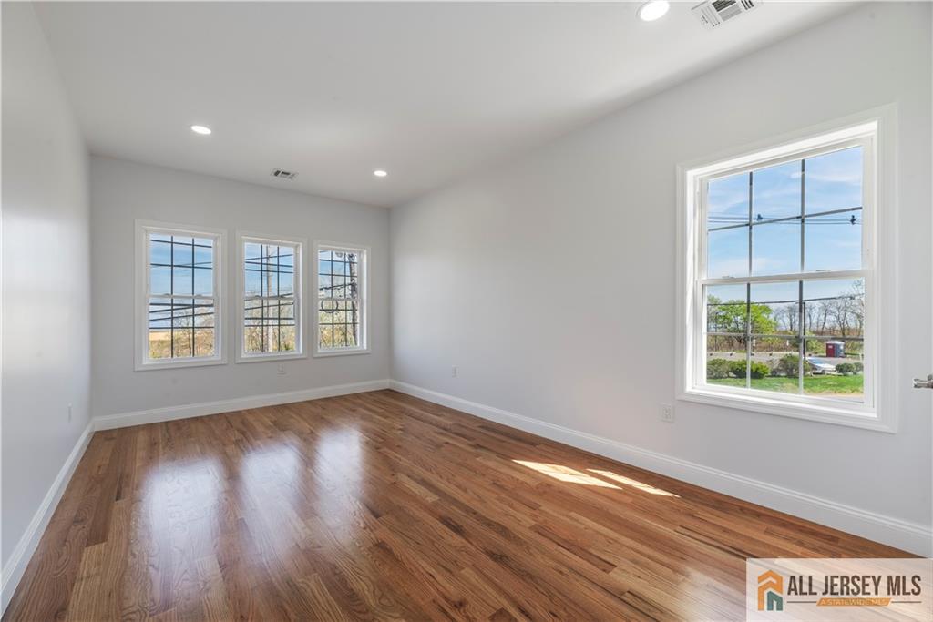 452 Raritan Boulevard Old Bridge, NJ 07735 - Photo 15 of 29 a view of an empty room with wooden floor and a window