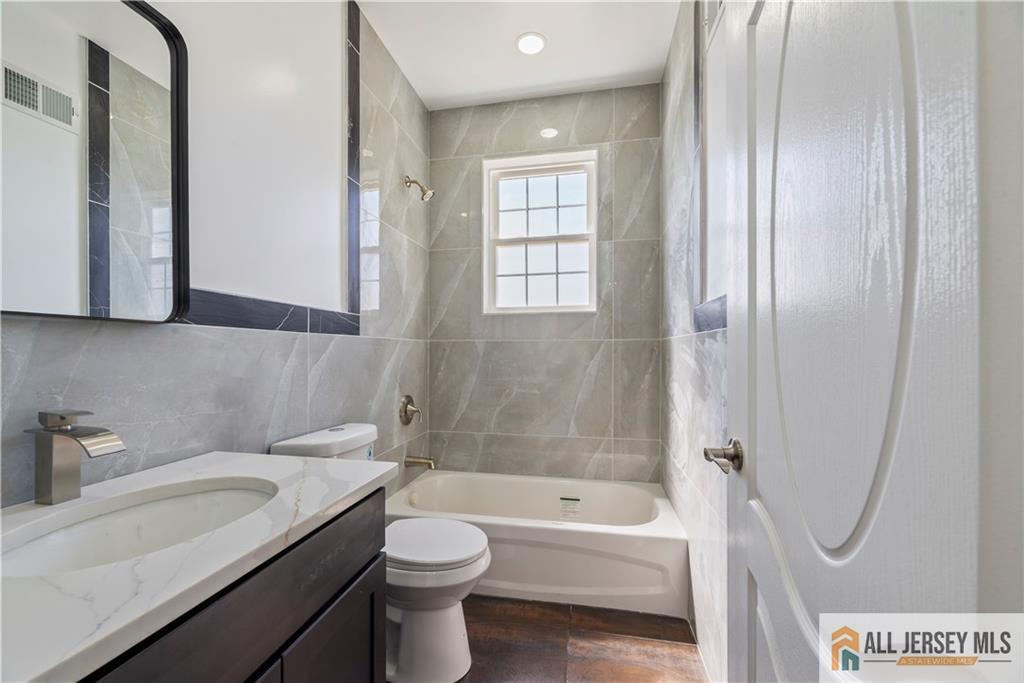452 Raritan Boulevard Old Bridge, NJ 07735 - Photo 18 of 29 a bathroom with a sink a toilet and shower