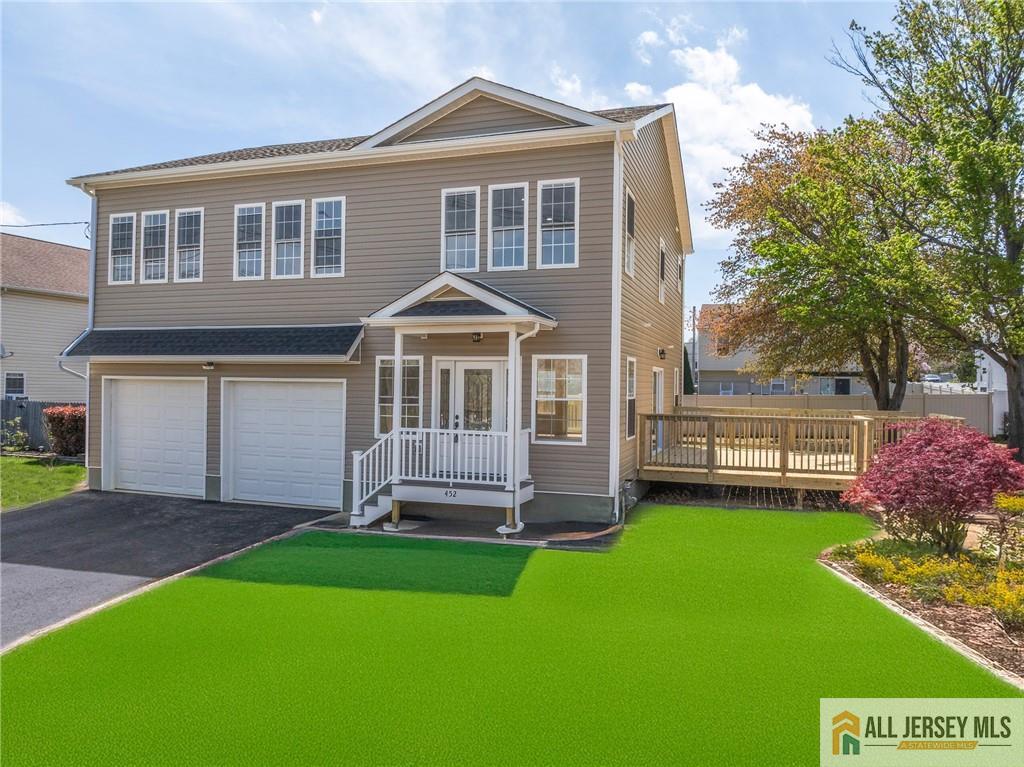 452 Raritan Boulevard Old Bridge, NJ 07735 - Photo 2 of 29 a front view of a house with a garden