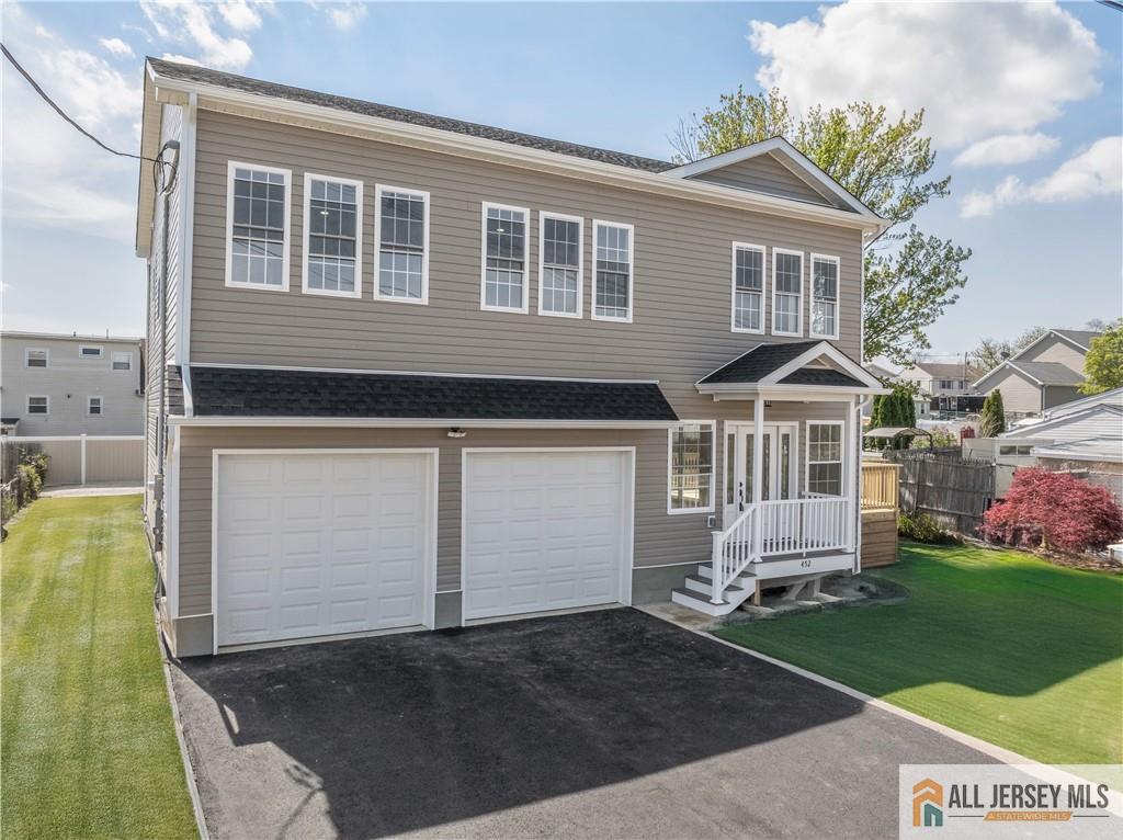 452 Raritan Boulevard Old Bridge, NJ 07735 - Photo 3 of 29 a front view of a house with a yard and garage