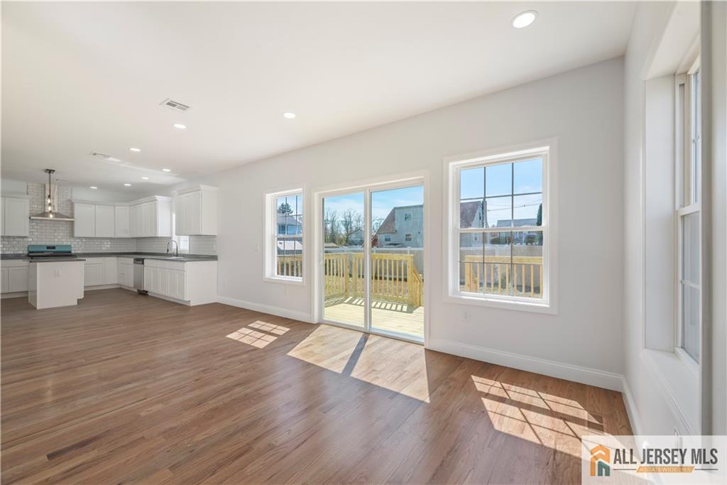 452 Raritan Boulevard Old Bridge, NJ 07735 - Photo 4 of 29 a view of an empty room with wooden floor and a window