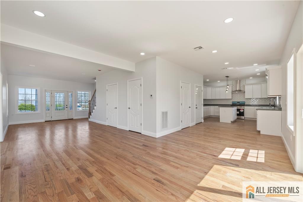 452 Raritan Boulevard Old Bridge, NJ 07735 - Photo 5 of 29 a view of kitchen with kitchen island wooden floor center island and stainless steel appliances