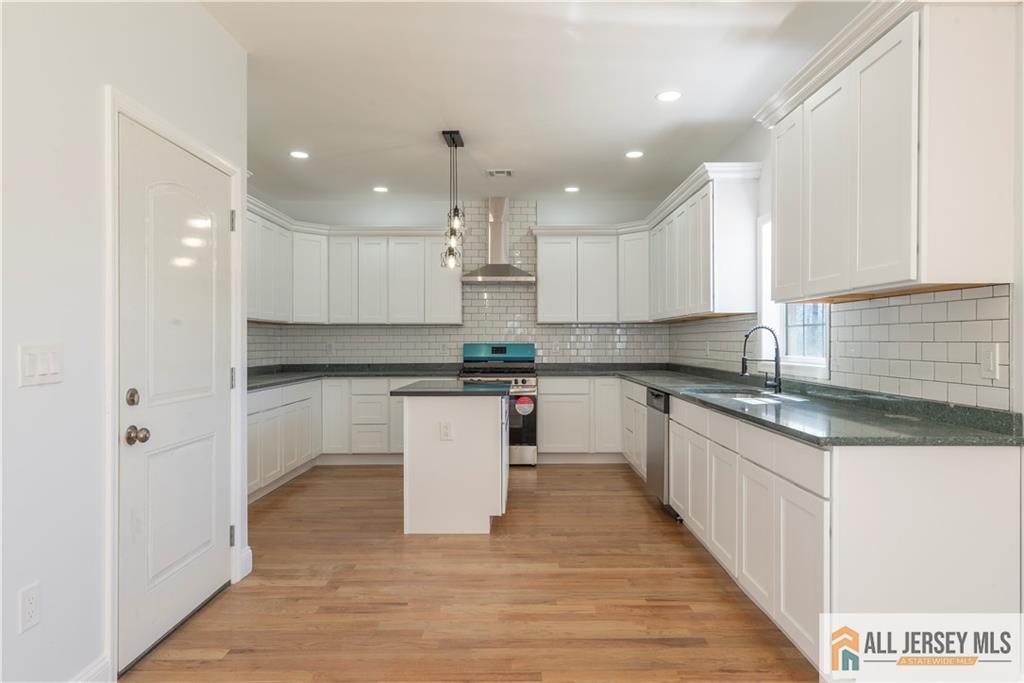 452 Raritan Boulevard Old Bridge, NJ 07735 - Photo 8 of 29 a kitchen with white cabinets appliances and a sink
