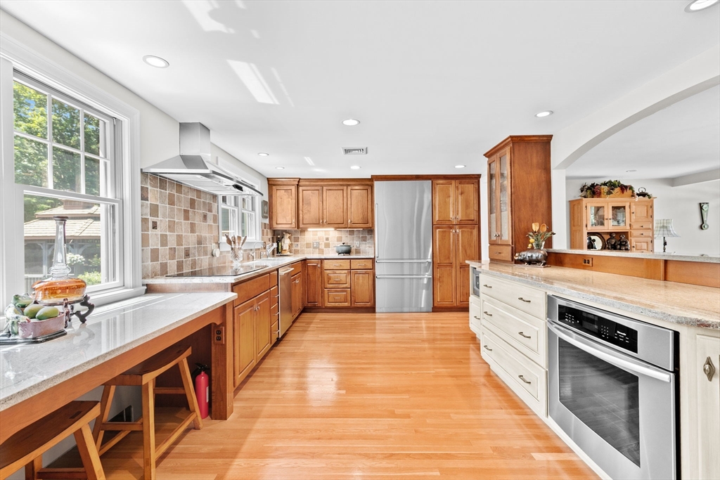 22 Marcus Road Sharon, MA 02067 - Photo 4 of 42 a large kitchen with stainless steel appliances kitchen island granite countertop a large counter top stainless steel appliances and windows